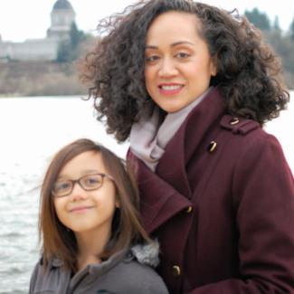 A woman and girl by a lake in front of the Capitol